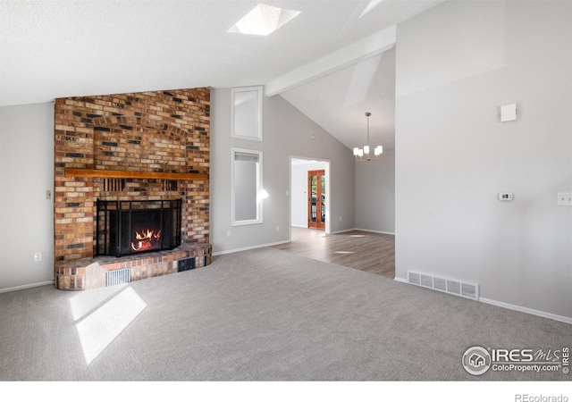 910 Sparta Dr, Lafayette, CO 80026 - unfurnished living room with visible vents, a chandelier, beamed ceiling, a fireplace, and carpet floors