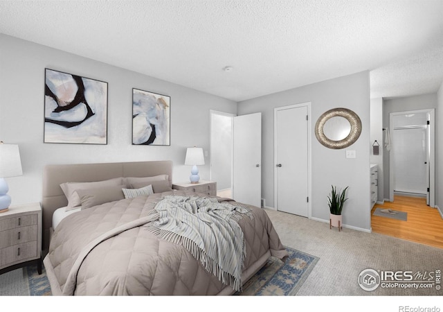 910 Sparta Dr, Lafayette, CO 80026 - bedroom featuring a textured ceiling, baseboards, and carpet