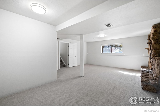 910 Sparta Dr, Lafayette, CO 80026 - basement featuring stairs, visible vents, and carpet floors