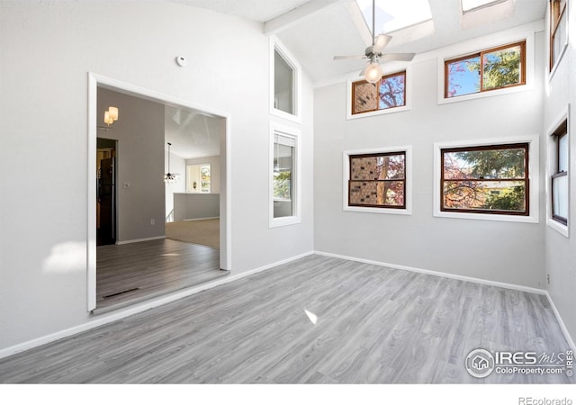 910 Sparta Dr, Lafayette, CO 80026 - unfurnished room with wood finished floors, high vaulted ceiling, baseboards, ceiling fan, and beamed ceiling