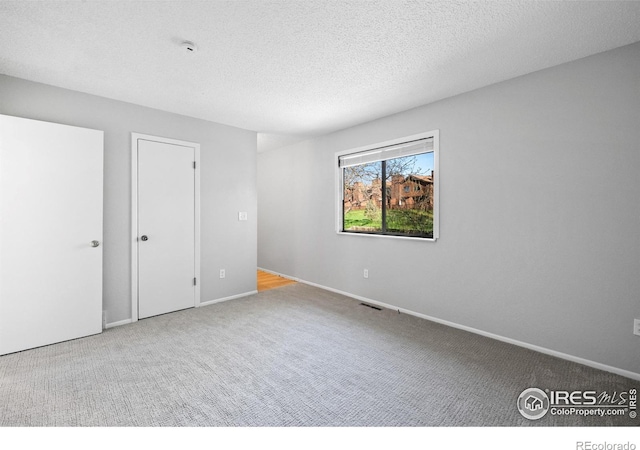 910 Sparta Dr, Lafayette, CO 80026 - unfurnished room featuring a textured ceiling, carpet flooring, and baseboards