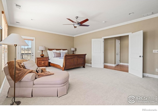 carpeted bedroom with baseboards, ornamental molding, and visible vents