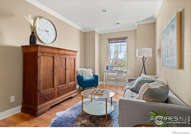 living area featuring light wood-type flooring, visible vents, baseboards, and ornamental molding