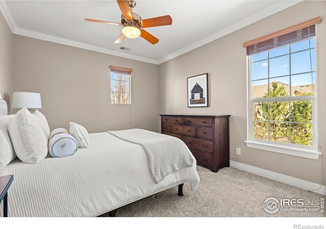 bedroom with visible vents, ornamental molding, carpet floors, baseboards, and ceiling fan
