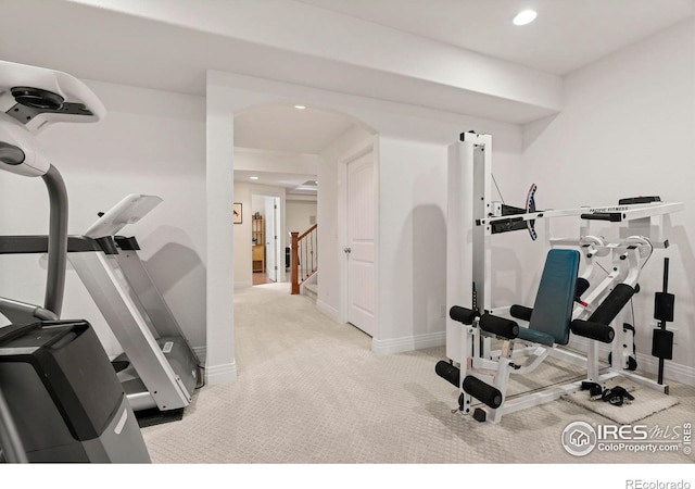 workout room with recessed lighting, arched walkways, carpet flooring, and baseboards