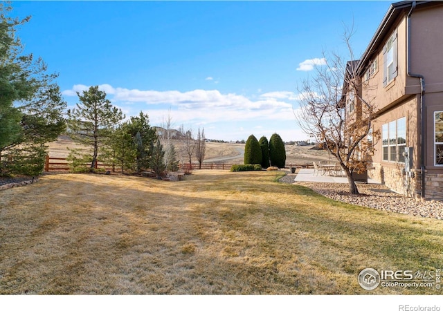 view of yard with fence and a patio area