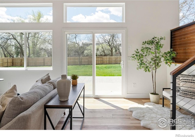 living area featuring wood finished floors and a towering ceiling