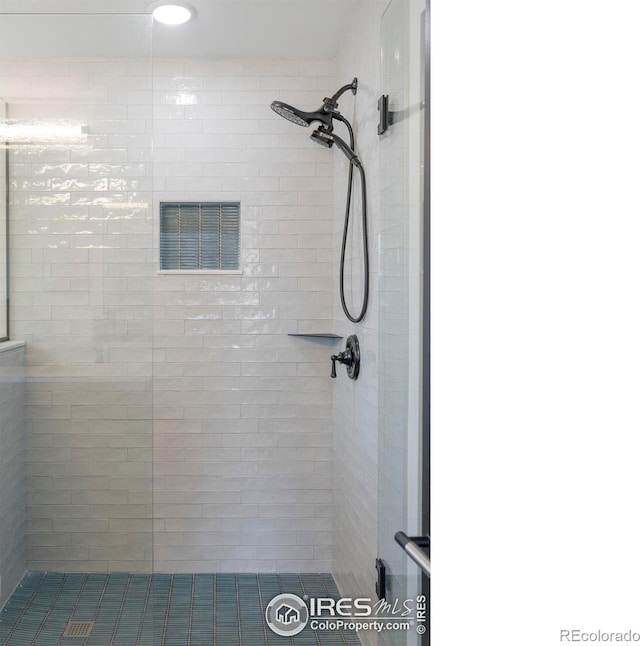 bathroom with visible vents and a stall shower