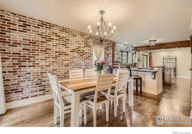 3707 Shelter Cv, Fort Collins, CO 80525 - dining area with brick wall, baseboards, a chandelier, wood finished floors, and recessed lighting