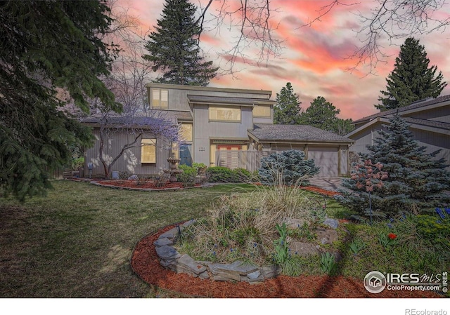3707 Shelter Cv, Fort Collins, CO 80525 - yard at dusk featuring an attached garage and a yard