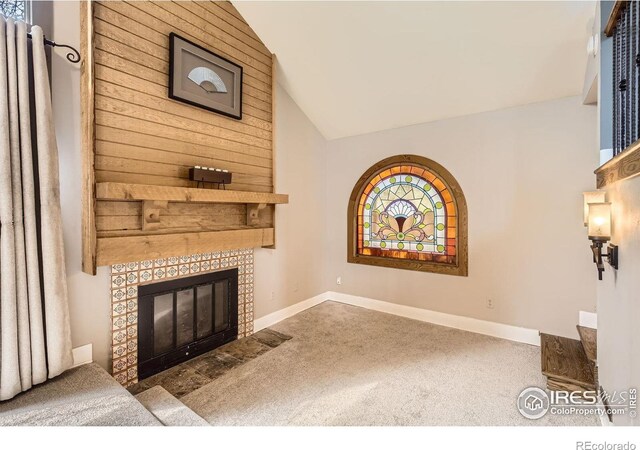 3707 Shelter Cv, Fort Collins, CO 80525 - unfurnished living room featuring carpet floors, lofted ceiling, a fireplace, and baseboards