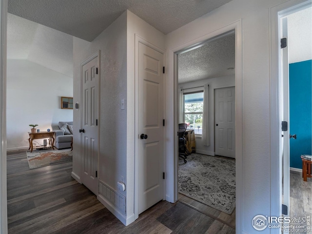 13146 Raritan Ct, Westminster, CO 80234 - corridor with baseboards, a textured ceiling, and dark wood finished floors