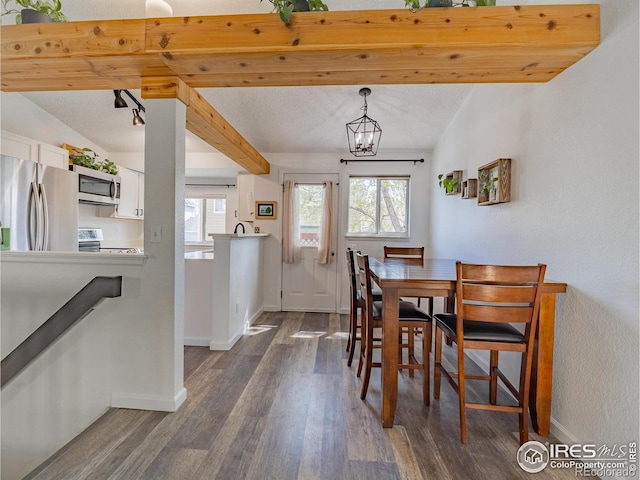 13146 Raritan Ct, Westminster, CO 80234 - dining space with a chandelier, baseboards, and dark wood finished floors