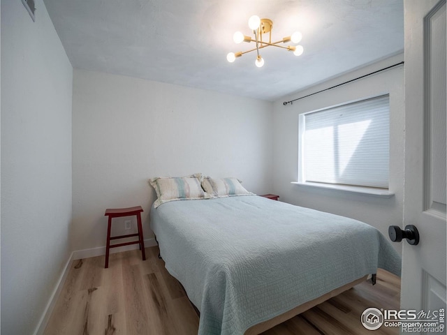 13146 Raritan Ct, Westminster, CO 80234 - bedroom with baseboards, visible vents, wood finished floors, and a chandelier