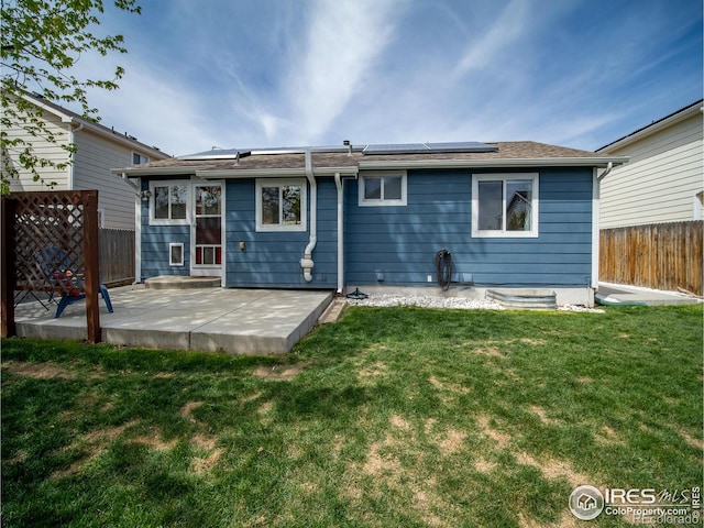 13146 Raritan Ct, Westminster, CO 80234 - rear view of house with roof mounted solar panels, fence, a yard, and a patio area