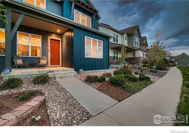 1356 Golden Eagle Way, Louisville, CO 80027 - view of exterior entry featuring a residential view, board and batten siding, and covered porch
