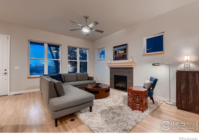 1356 Golden Eagle Way, Louisville, CO 80027 - living room with wood finished floors, visible vents, baseboards, a tiled fireplace, and ceiling fan