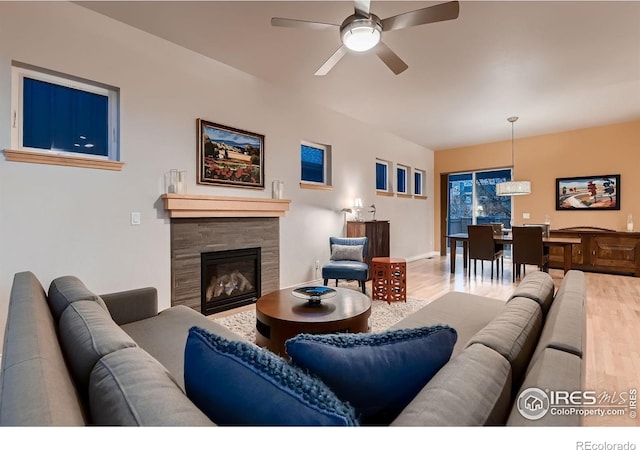 1356 Golden Eagle Way, Louisville, CO 80027 - living room with a glass covered fireplace, baseboards, wood finished floors, and ceiling fan