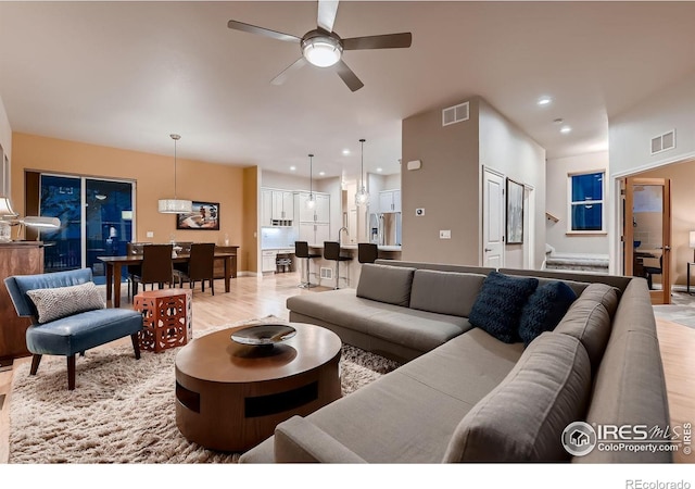 1356 Golden Eagle Way, Louisville, CO 80027 - living room featuring recessed lighting, light wood finished floors, visible vents, and a ceiling fan