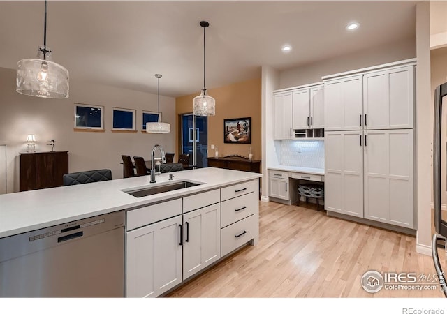 1356 Golden Eagle Way, Louisville, CO 80027 - kitchen featuring stainless steel dishwasher, a sink, light wood-style floors, light countertops, and hanging light fixtures