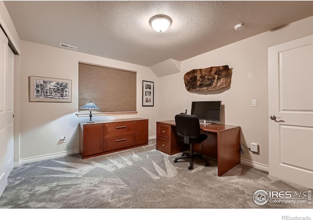 1356 Golden Eagle Way, Louisville, CO 80027 - office featuring vaulted ceiling, visible vents, light carpet, baseboards, and a textured ceiling