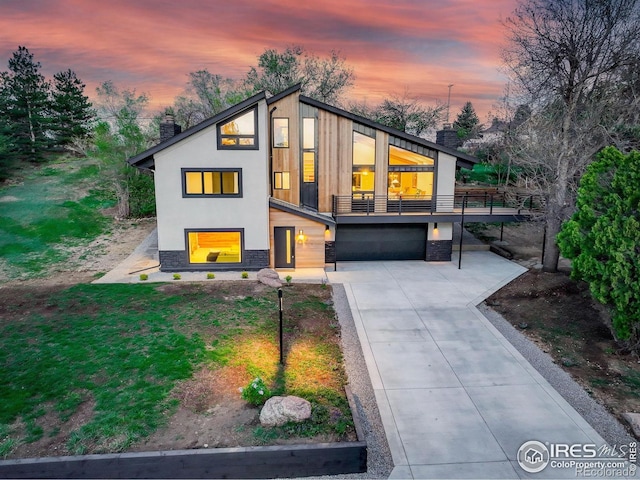1048 Westview Dr, Boulder, CO 80303 - view of front of house featuring a chimney, concrete driveway, an attached garage, stone siding, and stucco siding