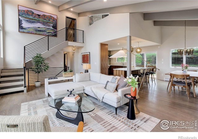 1048 Westview Dr, Boulder, CO 80303 - living area featuring a high ceiling, a chandelier, stairs, wood finished floors, and beamed ceiling