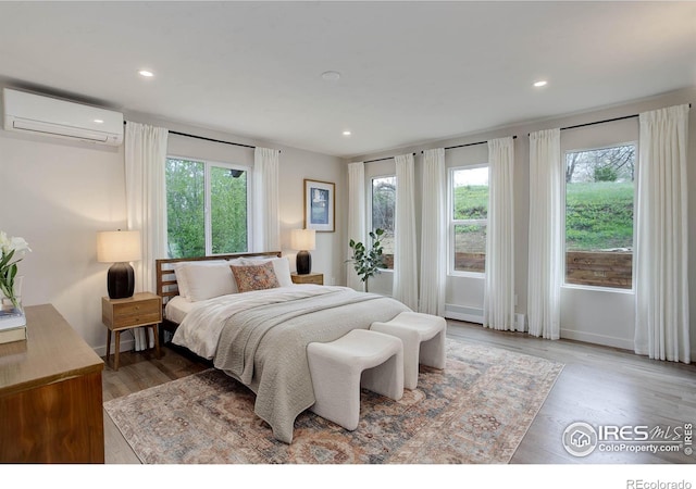 1048 Westview Dr, Boulder, CO 80303 - bedroom featuring recessed lighting, baseboards, wood finished floors, and a wall mounted air conditioner