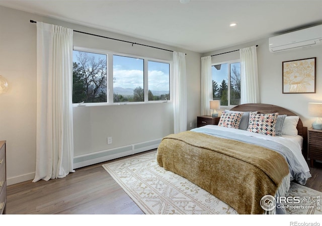 1048 Westview Dr, Boulder, CO 80303 - bedroom featuring baseboard heating, a wall mounted AC, wood finished floors, baseboards, and recessed lighting