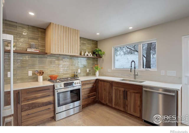 1048 Westview Dr, Boulder, CO 80303 - kitchen featuring tasteful backsplash, open shelves, a sink, light wood finished floors, and stainless steel appliances