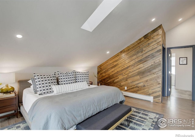 1048 Westview Dr, Boulder, CO 80303 - bedroom featuring wooden walls, a baseboard heating unit, recessed lighting, and wood finished floors