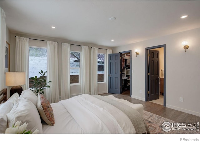 1048 Westview Dr, Boulder, CO 80303 - bedroom with recessed lighting, baseboards, wood finished floors, and a spacious closet