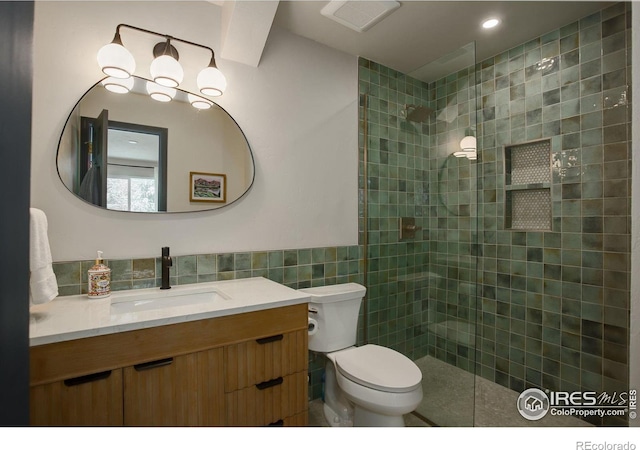 1048 Westview Dr, Boulder, CO 80303 - full bath with walk in shower, vanity, toilet, tile walls, and visible vents