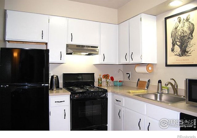 kitchen featuring a sink, light countertops, white cabinetry, under cabinet range hood, and black appliances