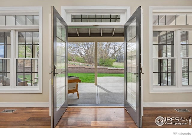 895 Owl Grove Pl, Loveland, CO 80537 - doorway to outside with wood finished floors, a healthy amount of sunlight, baseboards, and french doors