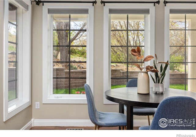 895 Owl Grove Pl, Loveland, CO 80537 - dining area featuring baseboards, visible vents, and a healthy amount of sunlight