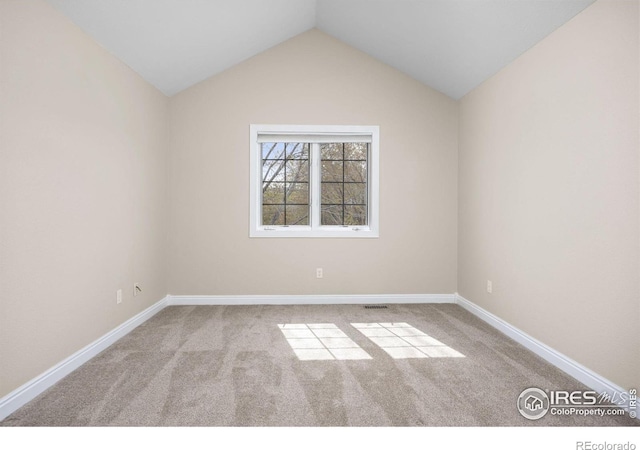 895 Owl Grove Pl, Loveland, CO 80537 - spare room with vaulted ceiling, carpet floors, and baseboards