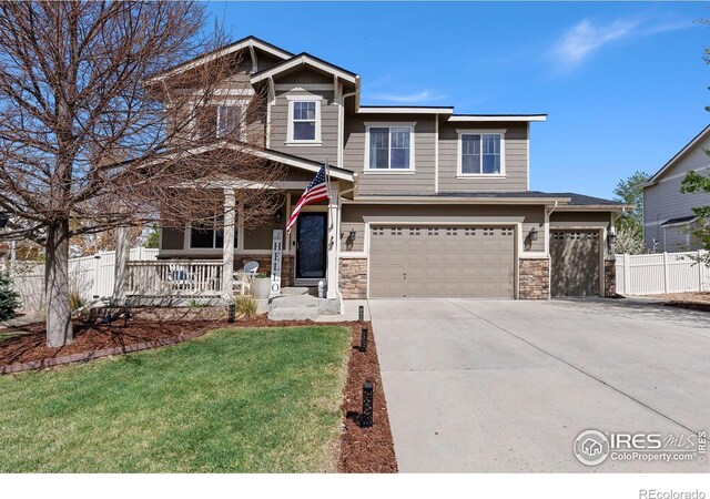 4737 Sandy Ridge Ave, Firestone, CO 80504 - craftsman-style home with driveway, stone siding, covered porch, an attached garage, and fence