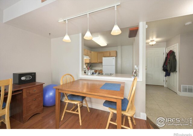 1020 Rolland Moore Dr Unit 2D, Fort Collins, CO 80526 - dining space with rail lighting, visible vents, baseboards, and light tile patterned floors