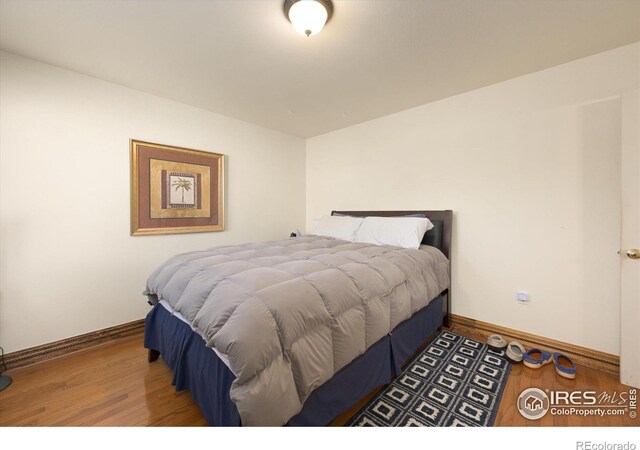 1020 Rolland Moore Dr Unit 2D, Fort Collins, CO 80526 - bedroom with baseboards and wood finished floors