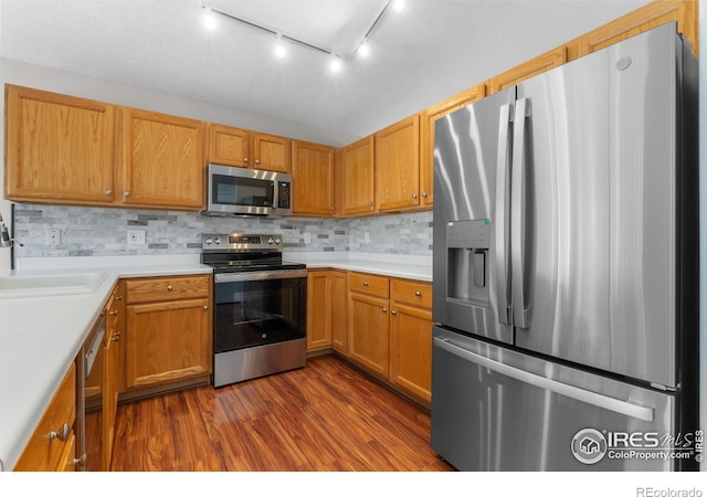 20336 Willowbend Ln, Parker, CO 80138 - kitchen featuring stainless steel appliances, dark wood finished floors, light countertops, and tasteful backsplash