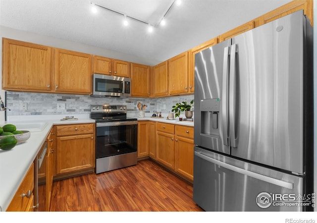 20336 Willowbend Ln, Parker, CO 80138 - kitchen featuring appliances with stainless steel finishes, dark wood-style floors, light countertops, and backsplash