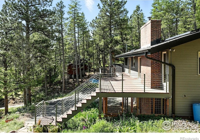 74 Sky Trail Rd, Boulder, CO 80302 - view of home's exterior with stairs, a chimney, and a deck