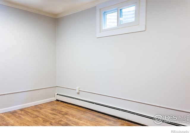 74 Sky Trail Rd, Boulder, CO 80302 - spare room featuring a baseboard heating unit, ornamental molding, and wood finished floors