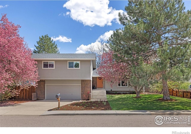 586 Aztec Dr, Boulder, CO 80303 - traditional-style home featuring an attached garage, a front yard, concrete driveway, and fence
