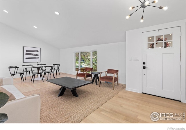 586 Aztec Dr, Boulder, CO 80303 - living room featuring light wood-type flooring, an inviting chandelier, recessed lighting, and lofted ceiling