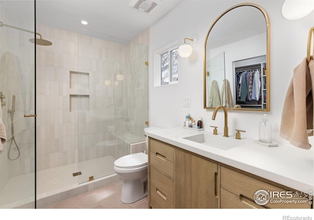 586 Aztec Dr, Boulder, CO 80303 - bathroom with toilet, visible vents, tile patterned flooring, a shower stall, and vanity
