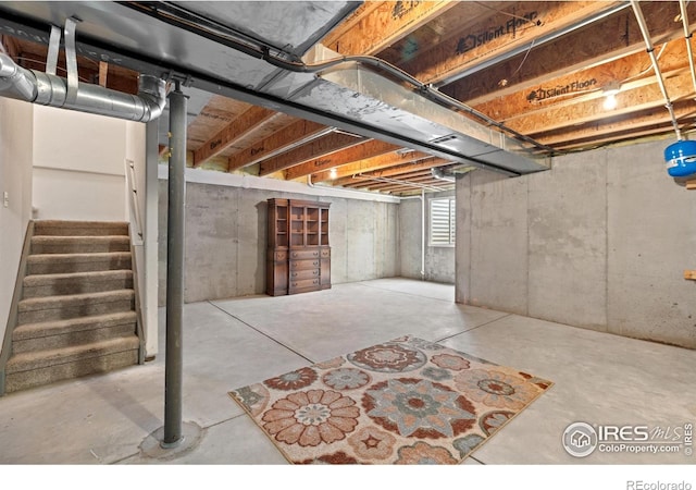 basement featuring stairs