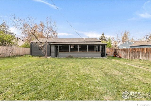 220 28th St, Boulder, CO 80305 - back of property with a fenced backyard, a sunroom, a lawn, and roof with shingles