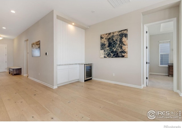 3351 Heron Lakes Pkwy, Berthoud, CO 80513 - spare room with light wood finished floors, wine cooler, visible vents, and recessed lighting